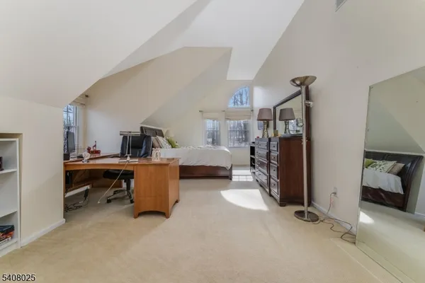 a view of a livingroom with workspace and a window