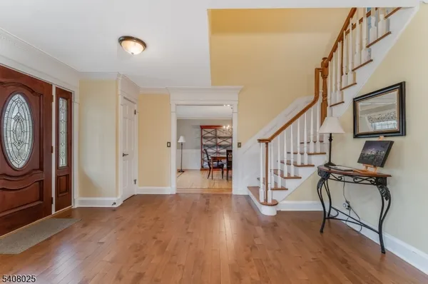 a view of an entryway with wooden floor and door