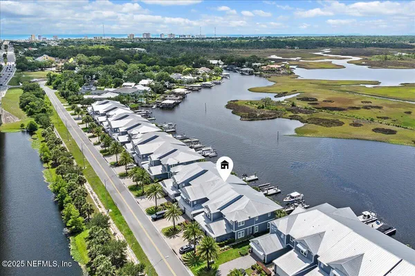 an aerial view of residential houses with outdoor space