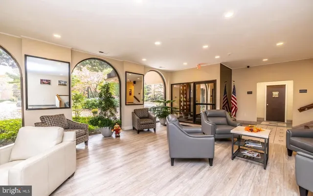 a living room with fireplace furniture and a large window
