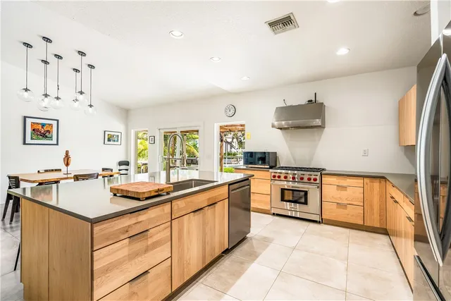 a kitchen with stainless steel appliances granite countertop a sink and cabinets