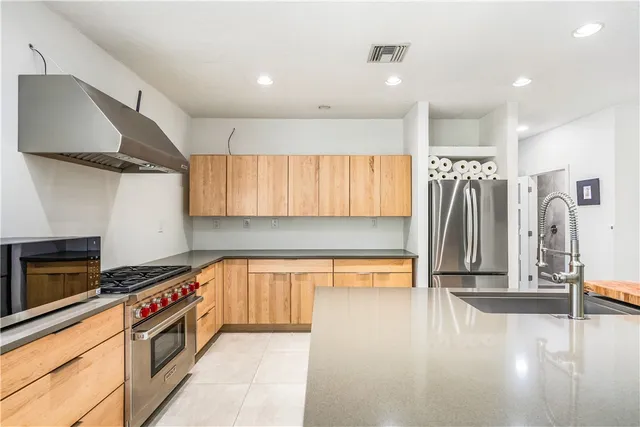 a kitchen with a sink a stove and cabinets