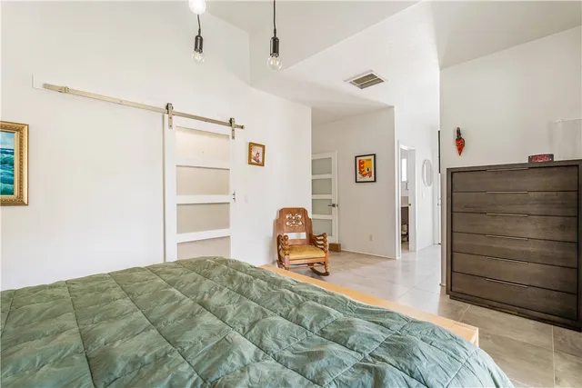 a bedroom with a bed and cabinets