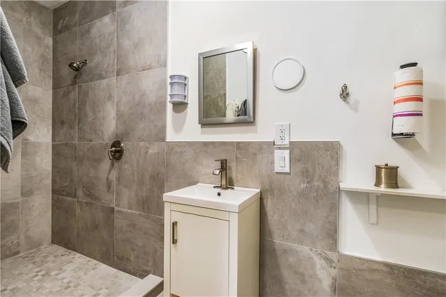 a bathroom with a sink mirror and shower