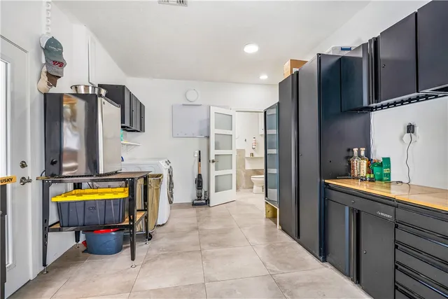 a kitchen with stainless steel appliances a refrigerator and a stove top oven