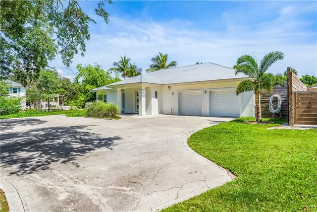 a front view of a house with a yard and a garage