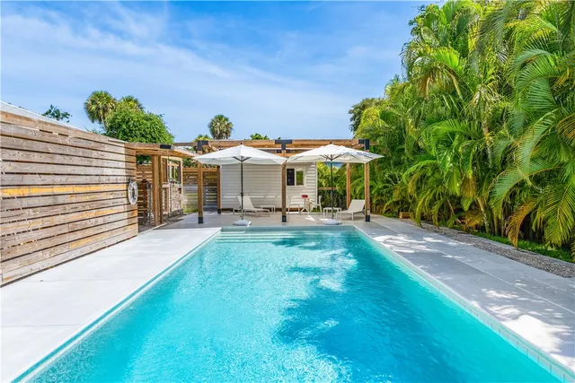 a view of a patio with chairs and a yard