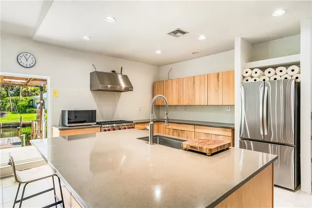 a kitchen with stainless steel appliances a stove sink and microwave