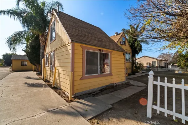 a view of a house with wooden fence