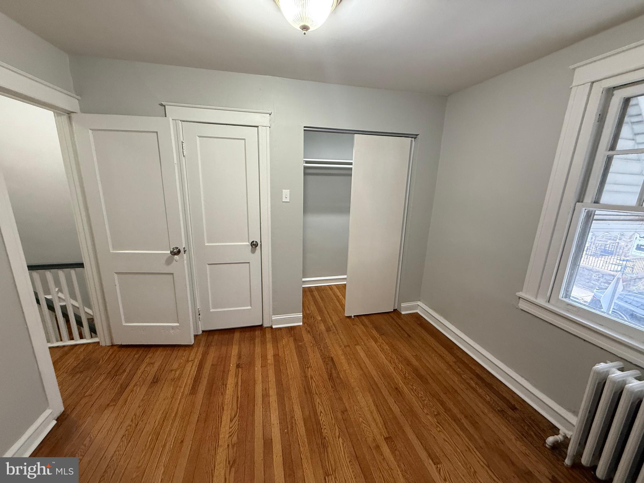 529 Timberlake Road Upper Darby, PA 19082 - Photo 13 of 28 a view of an empty room with wooden floor and a window