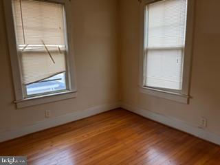 5945 Addison Road Capitol Heights, MD 20743 - Photo 7 of 9 a view of an empty room with wooden floor and a window