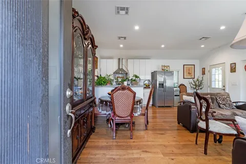 a kitchen with stainless steel appliances white cabinets and a stove top oven