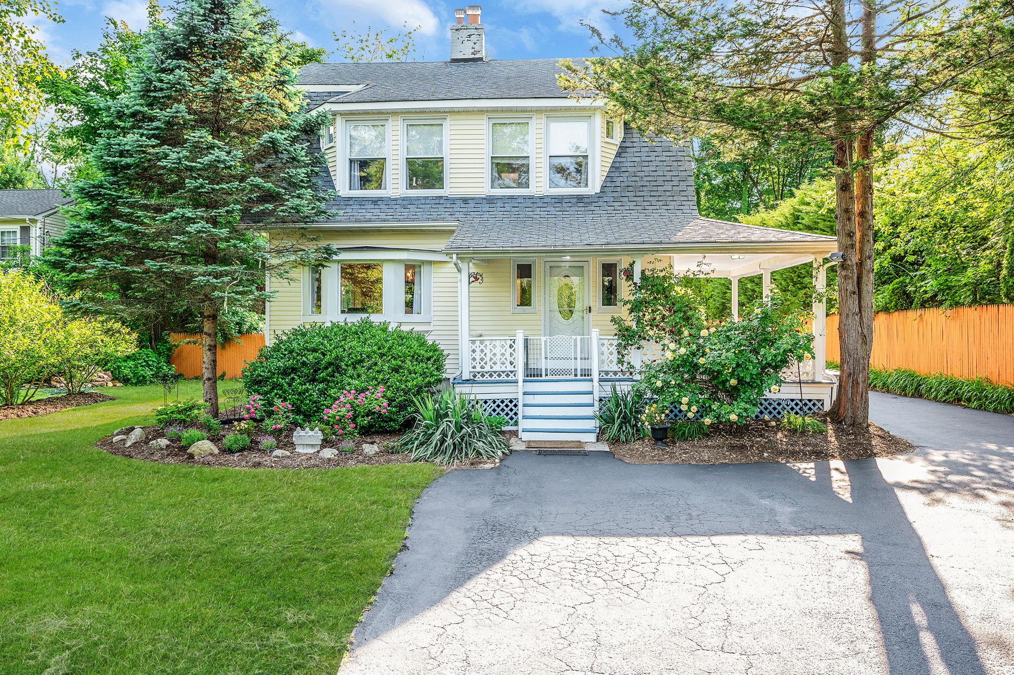 1 Centerport Road Greenlawn, NY 11740 - Photo 1 of 1 View of front facade with covered porch, roof with shingles, and a chimney