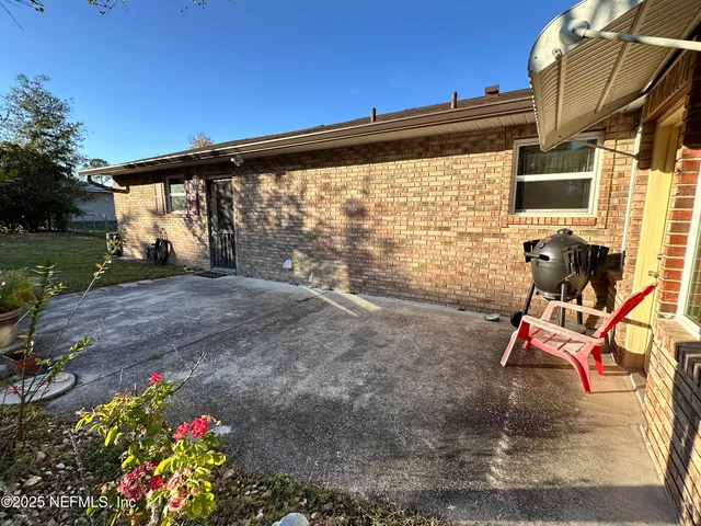 a backyard of a house with outdoor seating