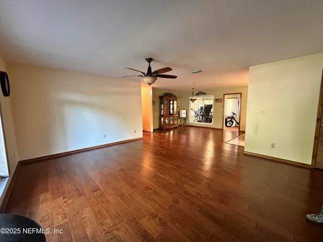 a view of an empty room and wooden floor