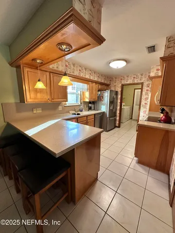 a kitchen with stainless steel appliances cabinets and a table