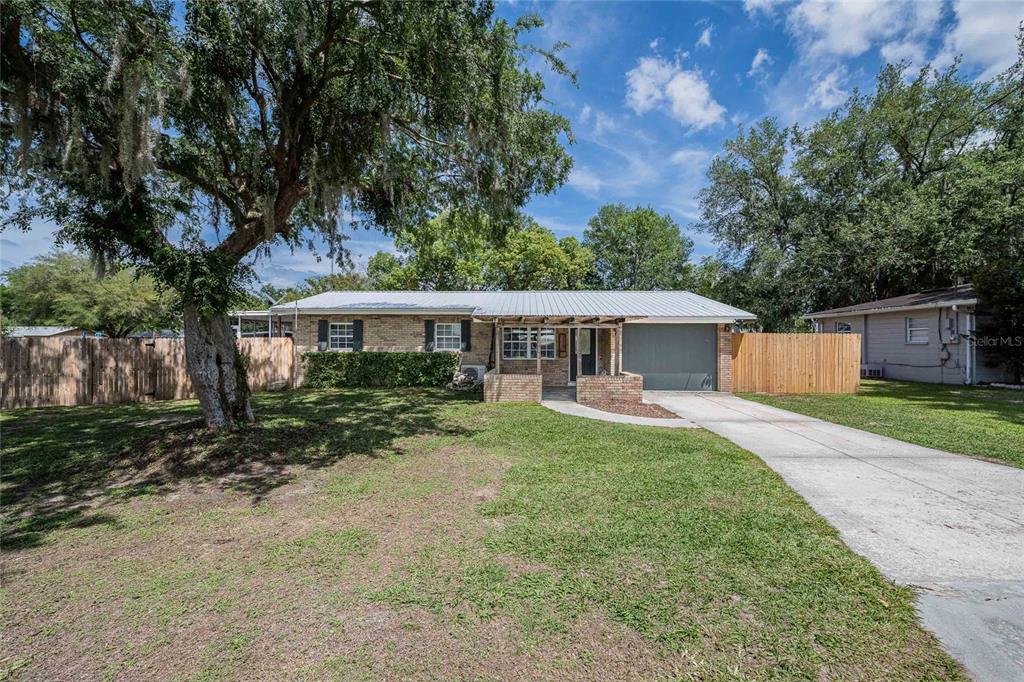 218 North Maple Lane Fort Meade, FL 33841 - Photo 1 of 37 a front view of a house with a yard and trees