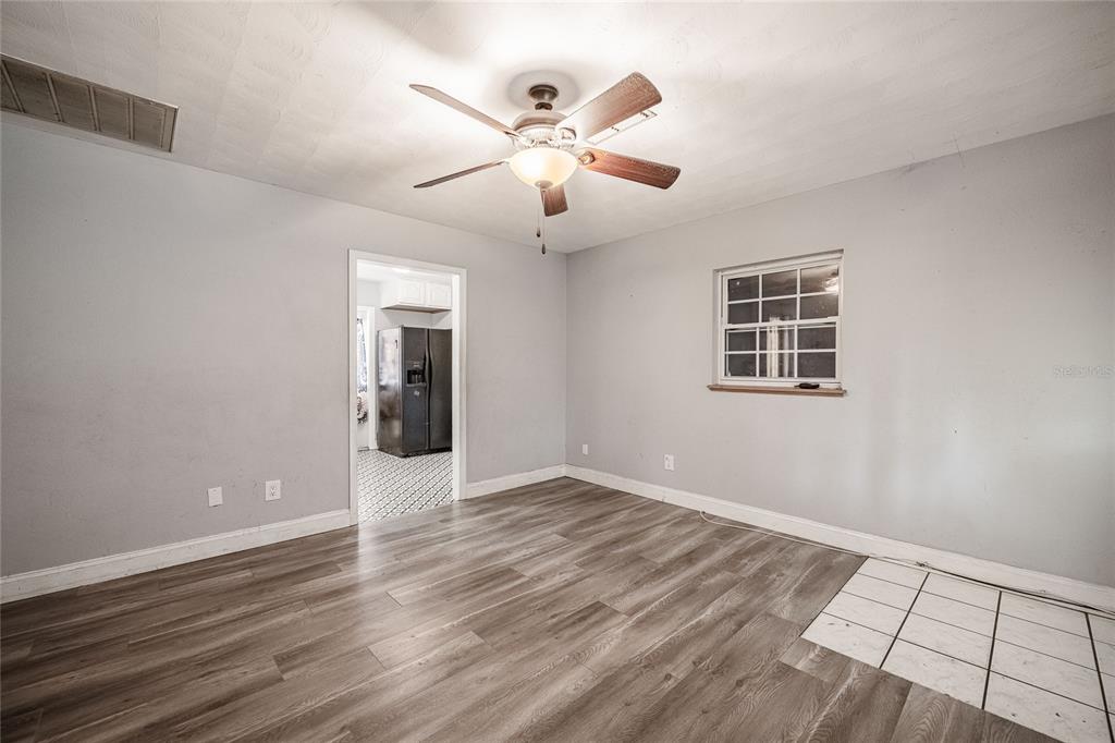 218 North Maple Lane Fort Meade, FL 33841 - Photo 16 of 37 wooden floor in an empty room with a window