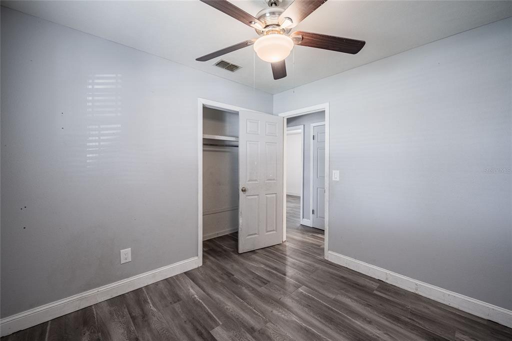 218 North Maple Lane Fort Meade, FL 33841 - Photo 19 of 37 wooden floor in an empty room with a fan
