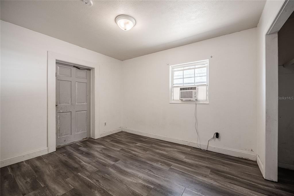 218 North Maple Lane Fort Meade, FL 33841 - Photo 20 of 37 an empty room with wooden floor and windows