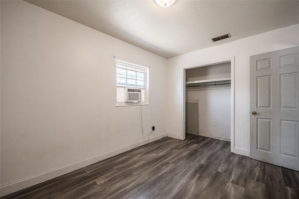 218 North Maple Lane Fort Meade, FL 33841 - Photo 21 of 37 a view of empty room with wooden floor and window
