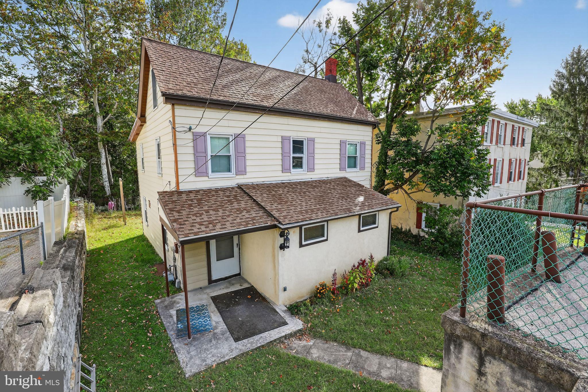 a aerial view of a house with a yard table and chairs