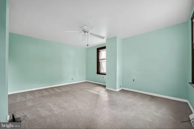 an empty room with a empty space and windows