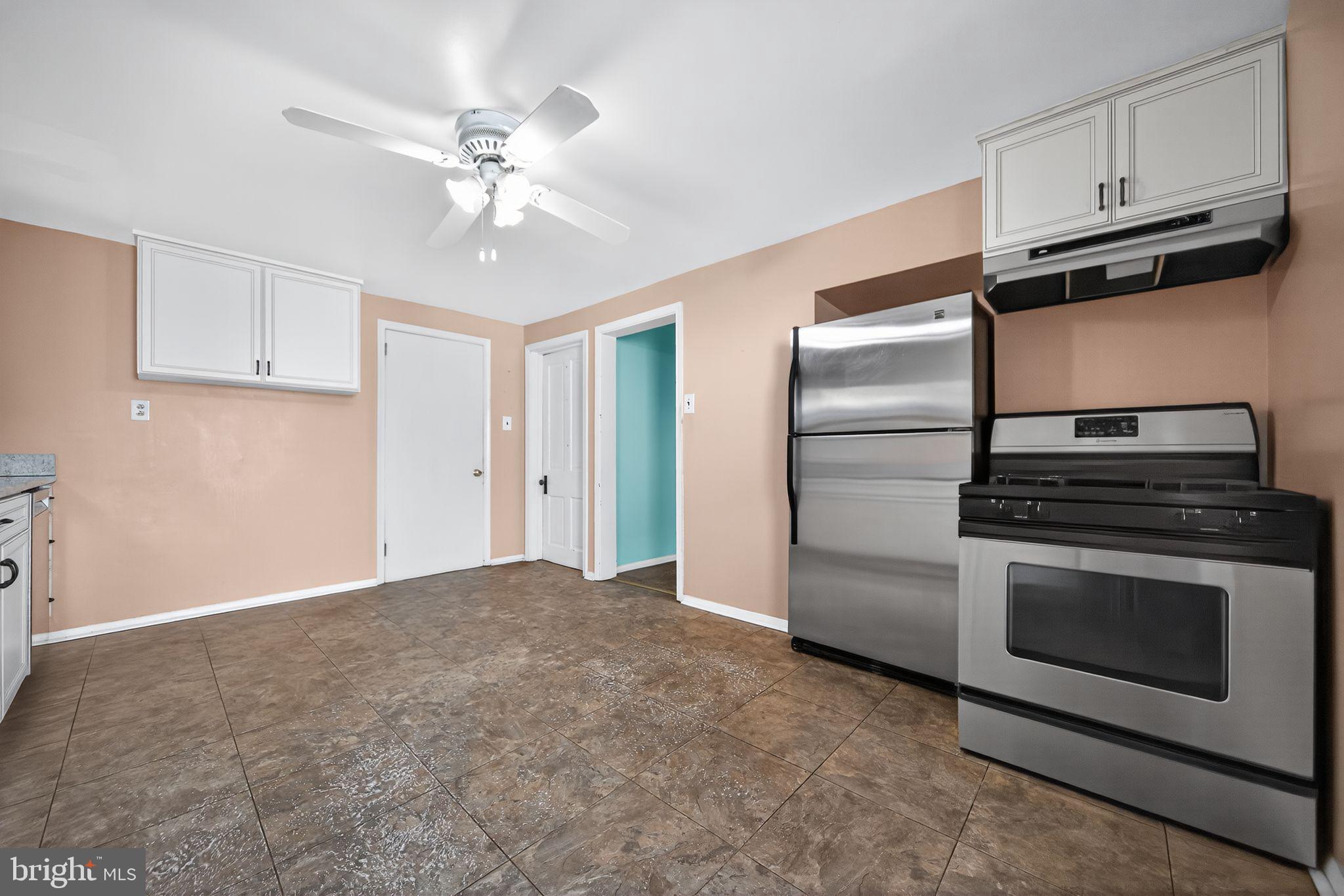 1196 Rebel Hill Road Conshohocken, PA 19428 - Photo 12 of 28 a kitchen with a refrigerator stove and white cabinets