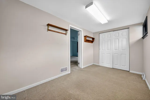 an empty room with closet area