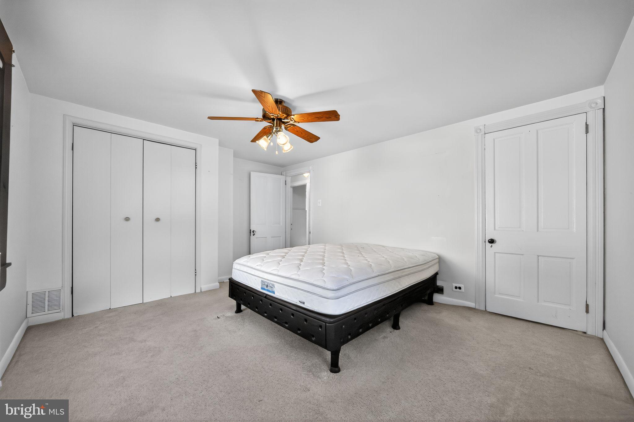 1196 Rebel Hill Road Conshohocken, PA 19428 - Photo 20 of 28 a bedroom with a bed and a ceiling fan