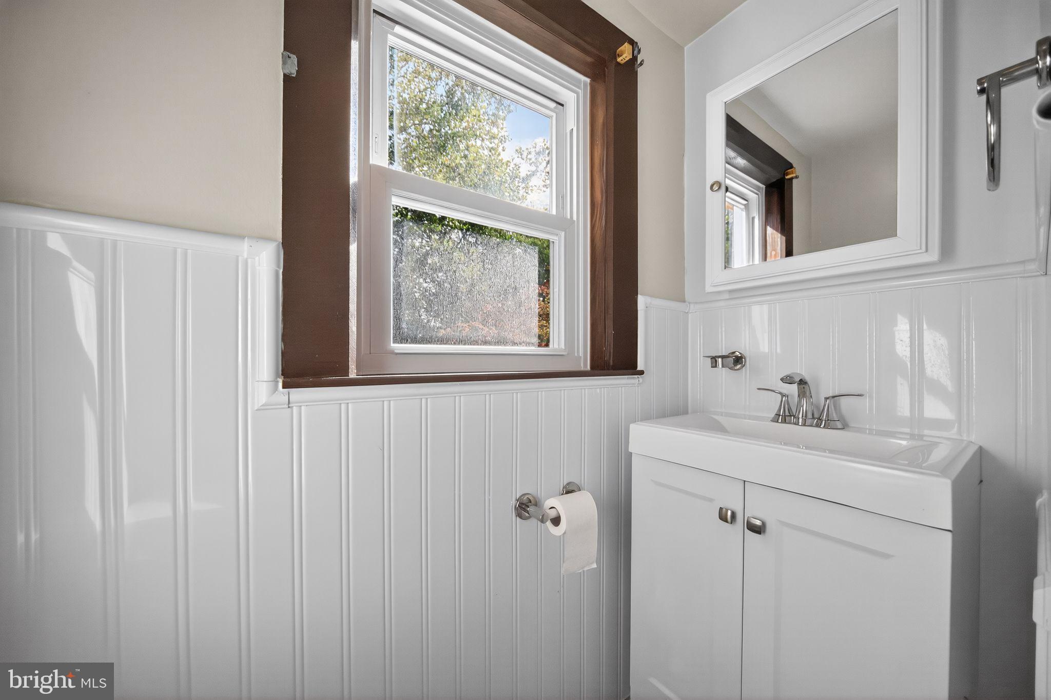 1196 Rebel Hill Road Conshohocken, PA 19428 - Photo 23 of 28 a bathroom with a granite countertop sink a mirror and a window