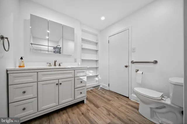 a spacious bathroom with a granite countertop sink toilet and shower