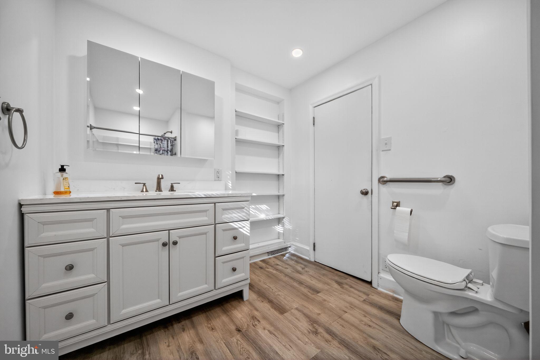 1196 Rebel Hill Road Conshohocken, PA 19428 - Photo 26 of 28 a spacious bathroom with a granite countertop sink toilet and shower