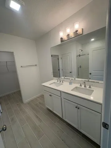 a bathroom with a double vanity sink and mirror