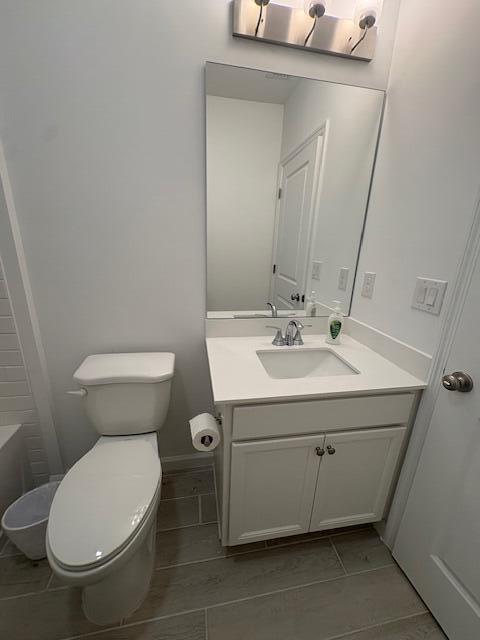 3197 Southwest Savona Boulevard Port St. Lucie, FL 34953 - Photo 18 of 34 a bathroom with a sink mirror and toilet