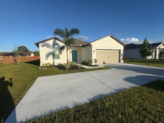 3197 Southwest Savona Boulevard Port St. Lucie, FL 34953 - Photo 2 of 34 a front view of a house with a yard