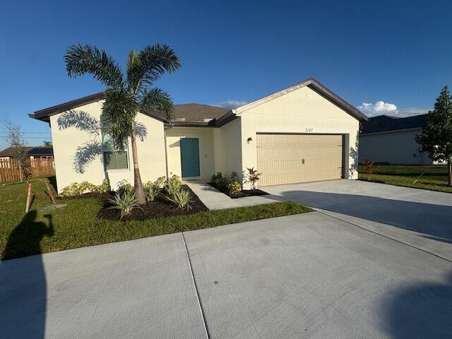 3197 Southwest Savona Boulevard Port St. Lucie, FL 34953 - Photo 3 of 34 a front view of a house with garden