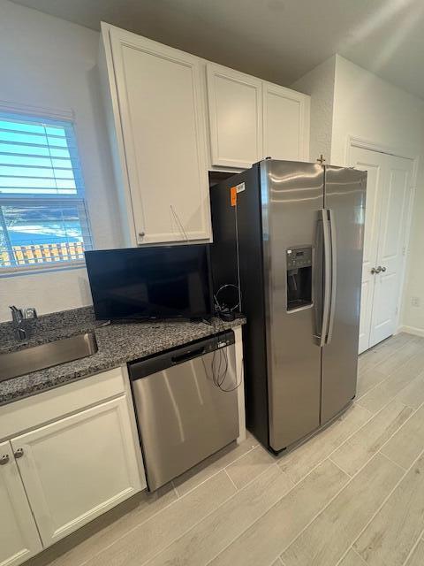 3197 Southwest Savona Boulevard Port St. Lucie, FL 34953 - Photo 8 of 34 a kitchen with stainless steel appliances granite countertop a refrigerator and a stove