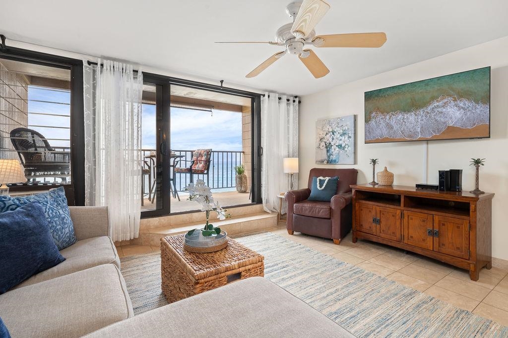 3785 Lower Honoapiilani Road, Unit 208 Lahaina, HI 96761 - Photo 18 of 50 a living room with furniture ceiling fan and a large window