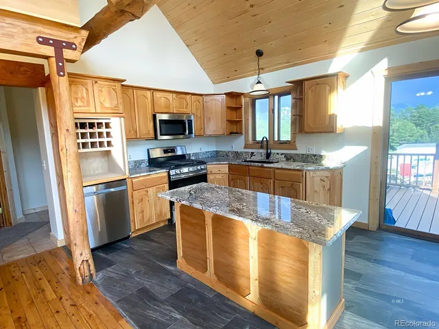 a kitchen with stainless steel appliances granite countertop a stove and a refrigerator