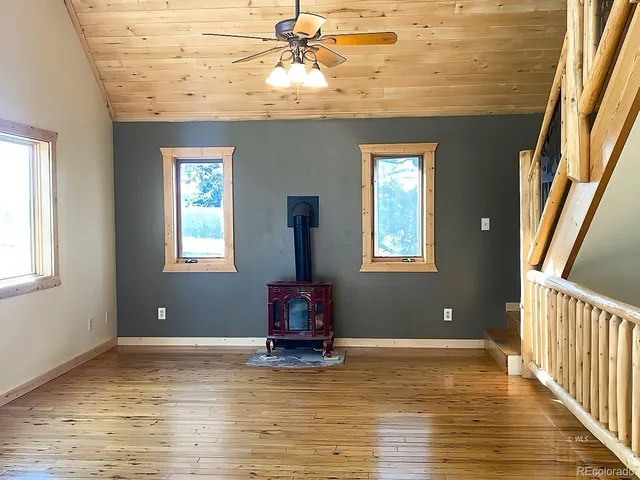 a view of a room with wooden floor and a window