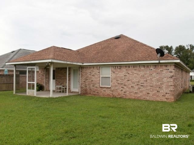 16976 Sugar Loop Foley, AL 36535 - Photo 14 of 16 Rear view of house with a yard and a patio area