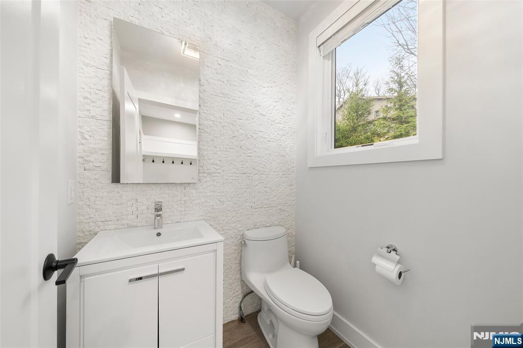55 Cedar Street Cresskill, NJ 07626 - Photo 17 of 40 a bathroom with a toilet sink and mirror