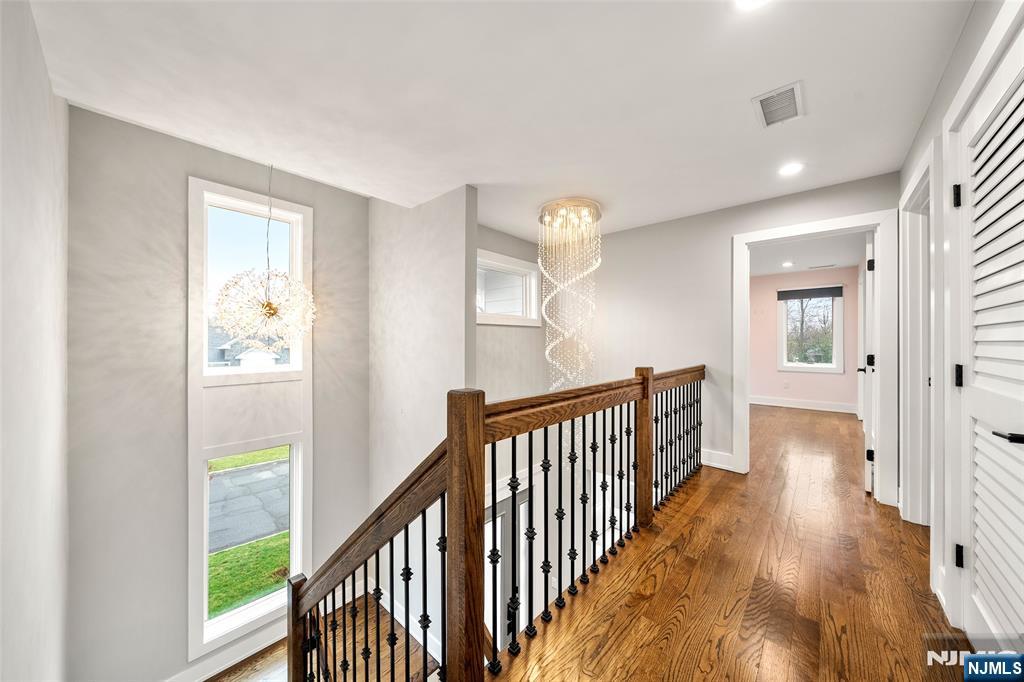 55 Cedar Street Cresskill, NJ 07626 - Photo 18 of 40 a view of a hallway with wooden floor and staircase