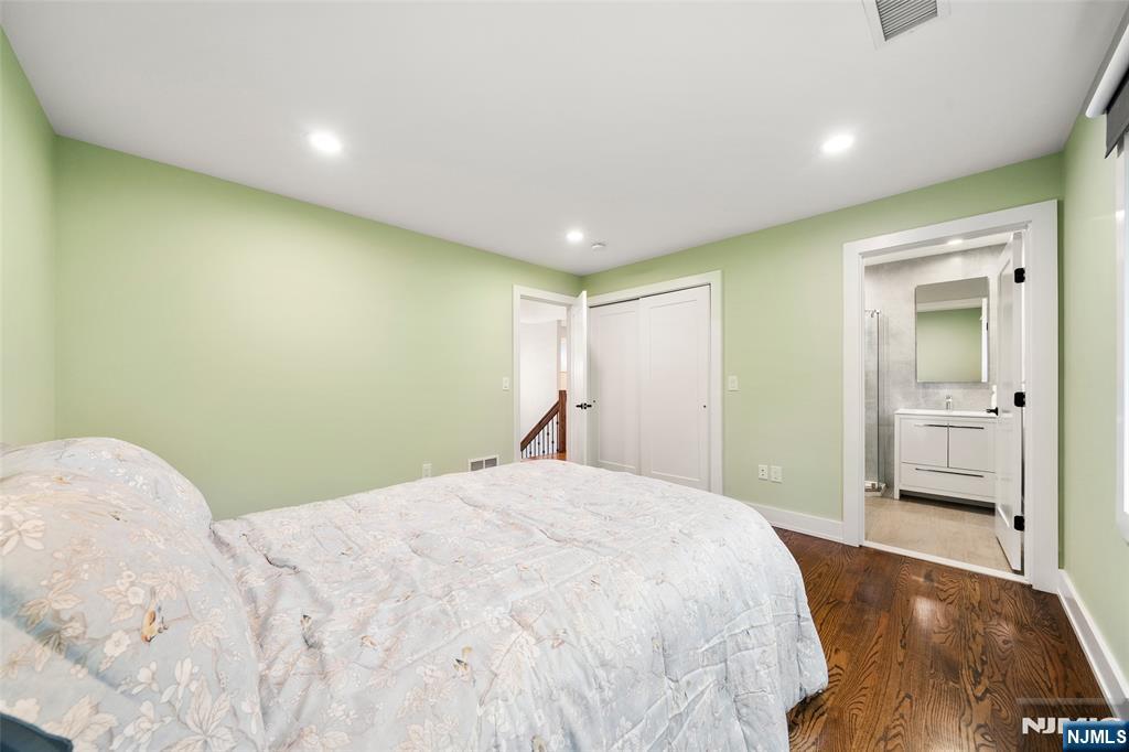 55 Cedar Street Cresskill, NJ 07626 - Photo 25 of 40 a bedroom with a bed and a mirror
