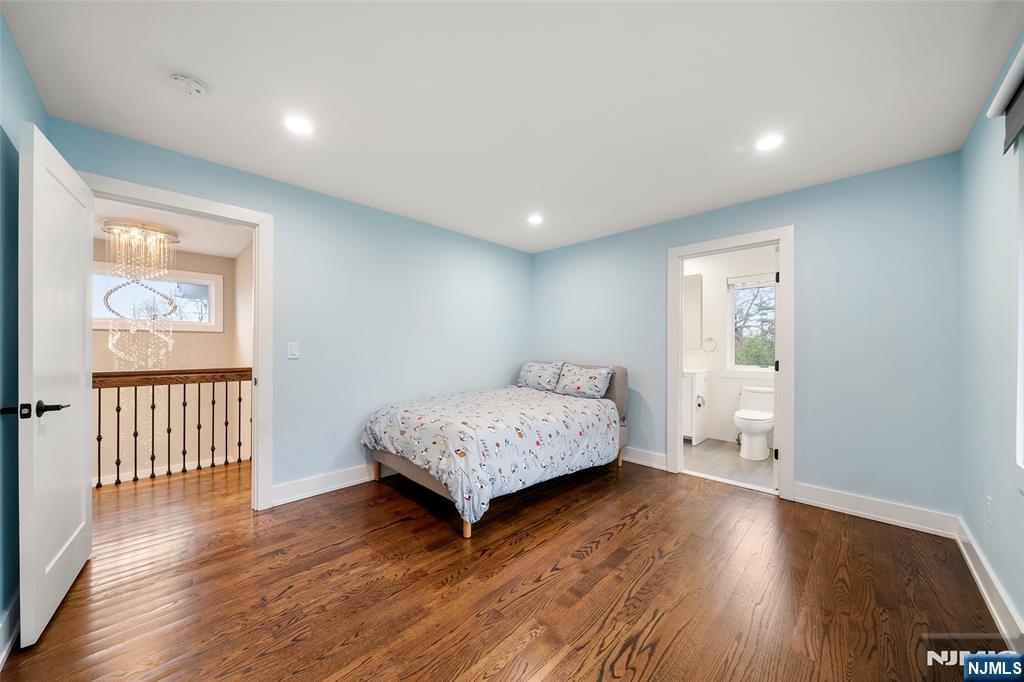 55 Cedar Street Cresskill, NJ 07626 - Photo 28 of 40 a spacious bedroom with a bed and wooden floor