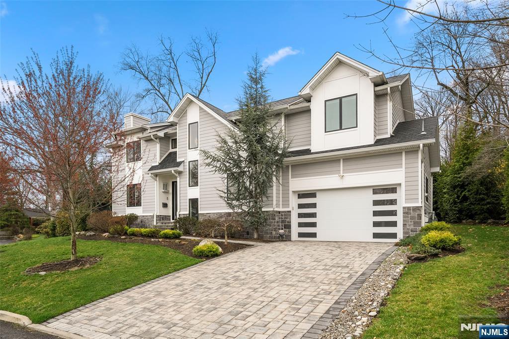 55 Cedar Street Cresskill, NJ 07626 - Photo 3 of 40 a front view of a house with a yard and garage
