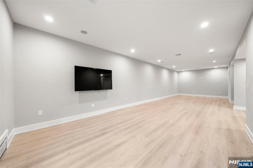 55 Cedar Street Cresskill, NJ 07626 - Photo 33 of 40 a view of an empty room with wooden floor and a window