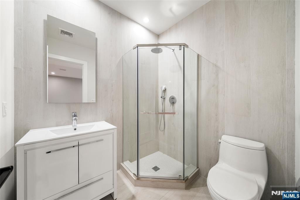 55 Cedar Street Cresskill, NJ 07626 - Photo 35 of 40 a bathroom with a toilet sink and shower