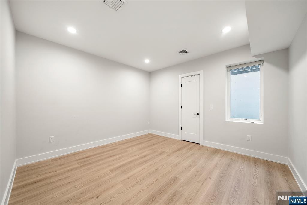 55 Cedar Street Cresskill, NJ 07626 - Photo 36 of 40 an empty room with wooden floor and windows